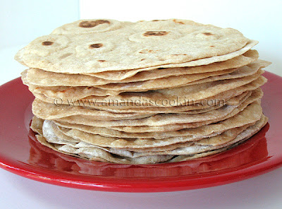 A close up photo of a stack of low fat homemade flour tortillas.