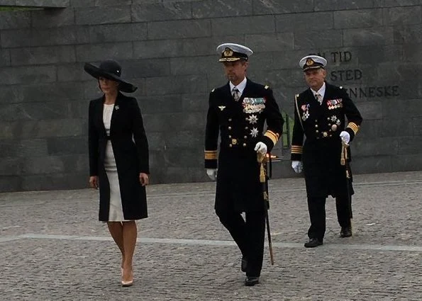 Prince Frederik and Crown Princess Mary at wreath-laying ceremony Prada Cappotto black coat. Gianvito Rossi Pumps, Hugo Boss clutch