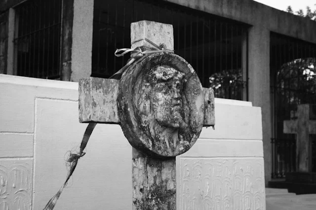 A cross on top of a tomb at La Loma Cemetery