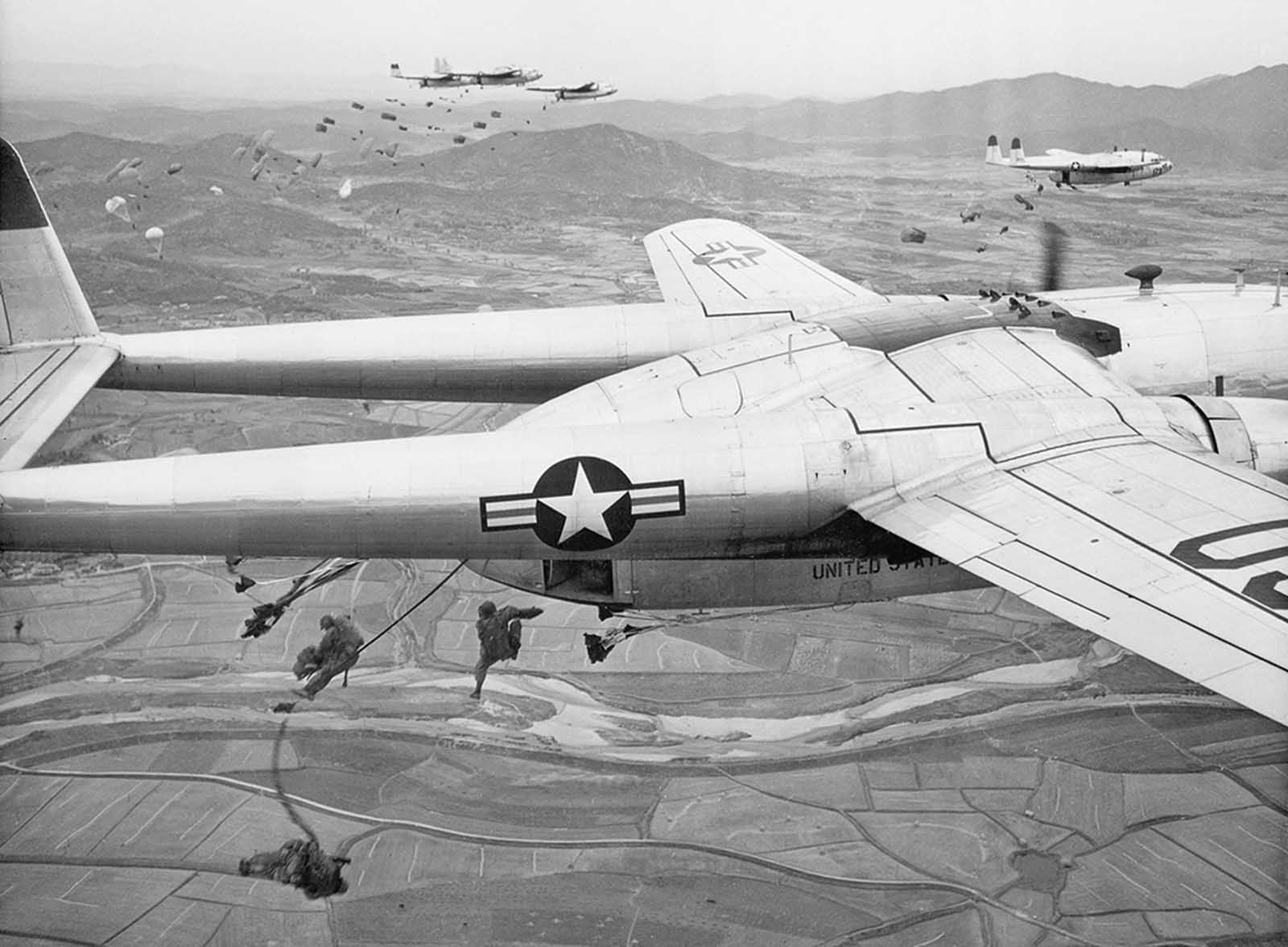 Paratroopers drop from U.S. Air Force C-119 transport planes during an operation over an undisclosed location in Korea, in October of 1950.