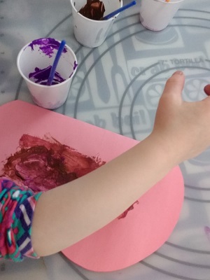 Toddler painting one half of the butterfly