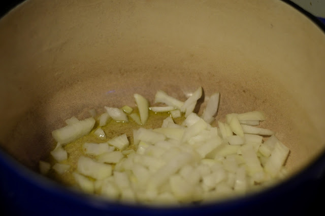 Diced white onion cooking in the pot. 