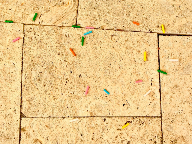 plastic sprinkles of various colors on some bricks