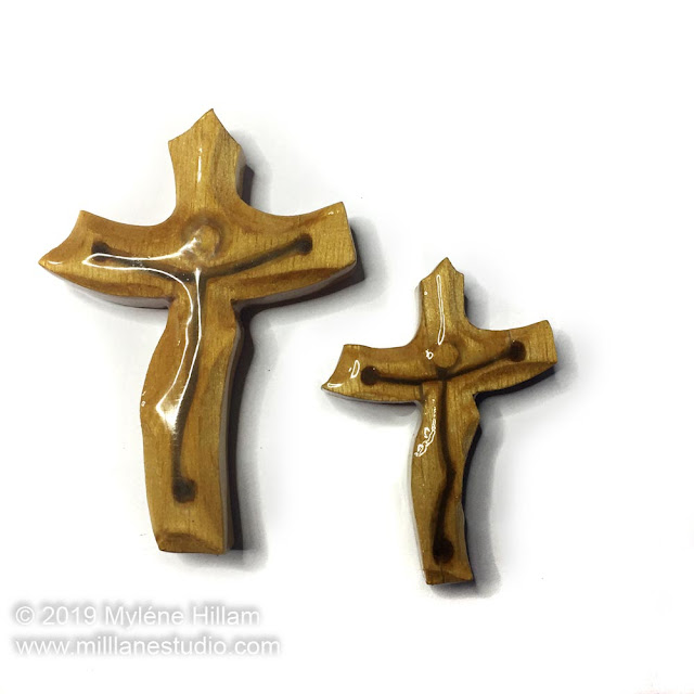 Large and small wooden crucifix coated with resin