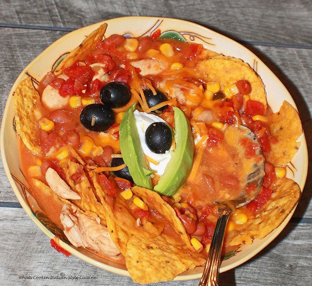This is a bowl of easy taco soup and how to make it with olives and avocado garnishings