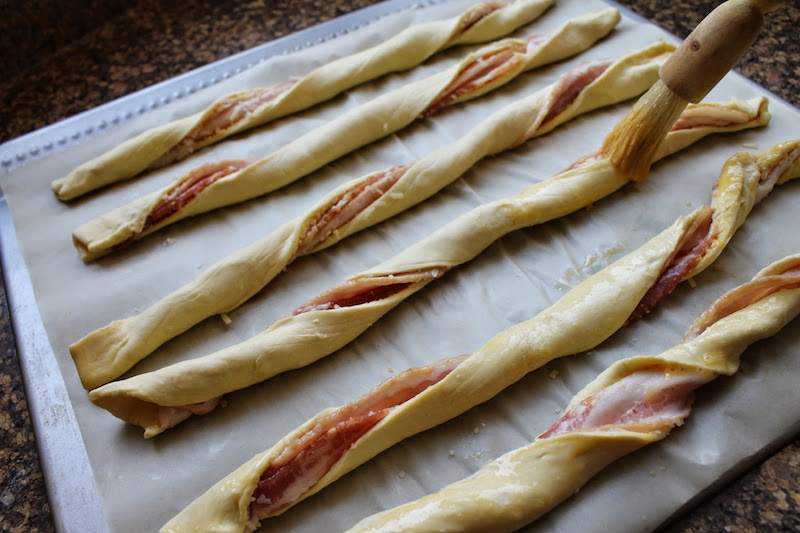 Food Lust People Love: Puff pastry spread with Dijon and sprinkled with Parmesan, then twisted with streaky bacon, is baked till it's crispy, puffed and golden. Bacon Parmesan Twists are a divine savory snack!