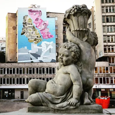 Cherub statue and street art in Warsaw, Poland