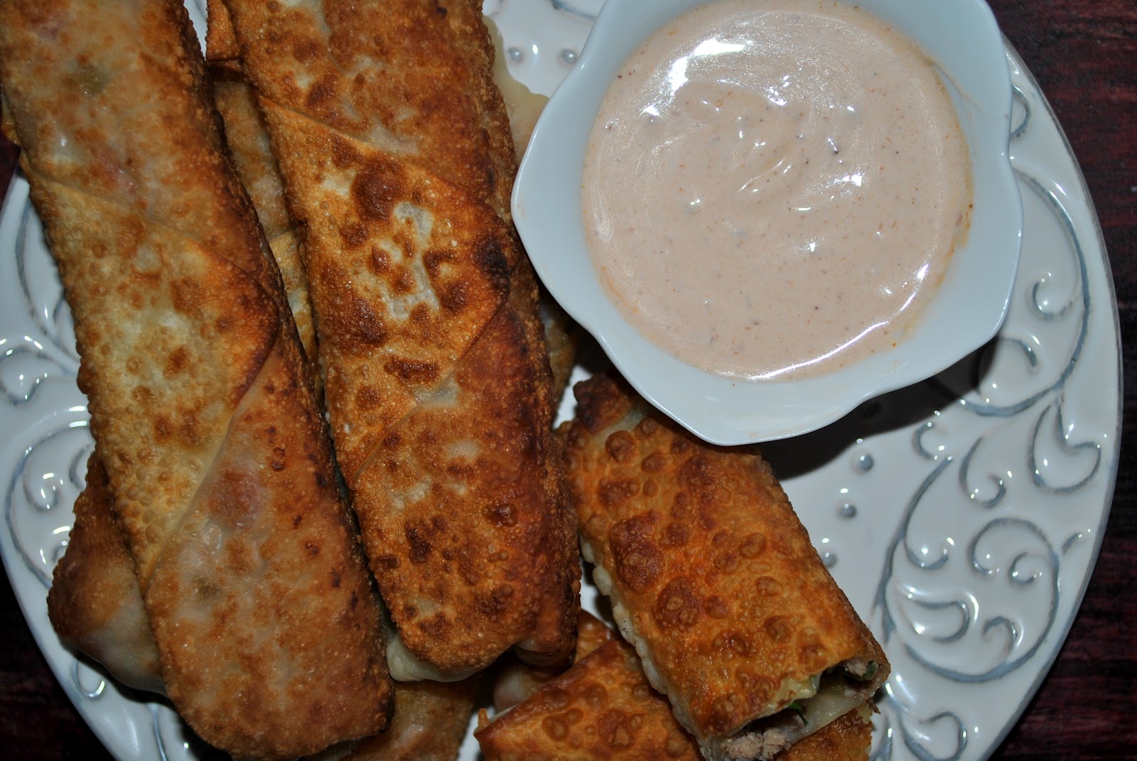 cheesy taco egg rolls w/ spicy sour crema