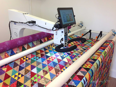 Half Square Triangle Quilt on the longarm quilting machine
