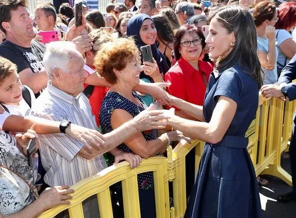 Queen Letizia wore Carolina Herrera denim shirt dress. Carolina Herrera clutch. President Ximo Puig