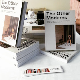 Display of copies of the book The Other Moderns on a table.