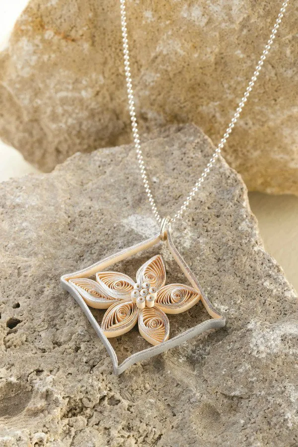 silver quilled paper diamond flower pendant on a silver necklace chain