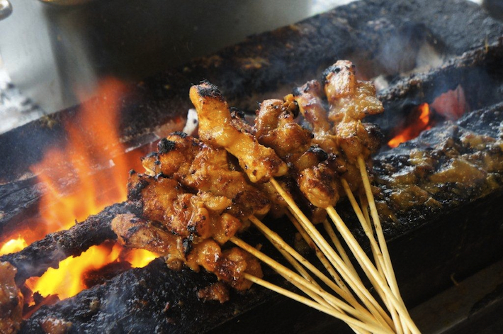 Chicken satay cooking over fire in Kajang, Malaysia - featured on SeasonWithSpice.com