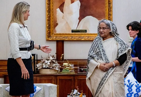 Queen Maxima wore a floral print silk blouse and floral print silk midi skirt, and Ntan pumps, fruit earrings, One & Only clutch