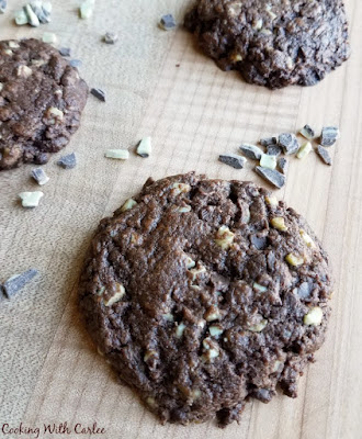 Chewy chocolate cookies packed completely full with chocolate and mint candy bits. They are festive, easy and sure to please! close up of large chocolaty cookies