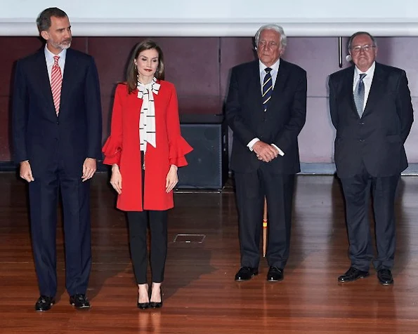 Queen Letizia wore a Zara Frilled Sleeve Coat and Roberto Verino Blouse, Carolina Herrera black-patent and suede pumps and carried Carolina Herrera Animal Print Clutch Bag