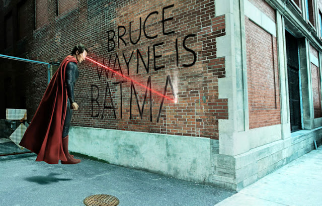 superman haciendo una pintada en una pared