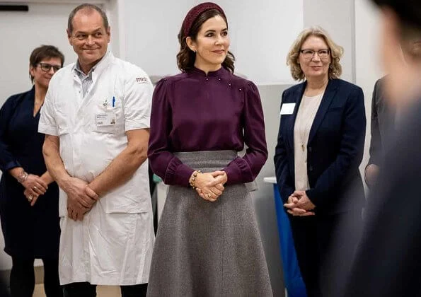 Crown Princess Mary attended the opening of Viborg Regional Hospital's new emergency center. burgundy blouse, grey midi dkirt, grey wool coat