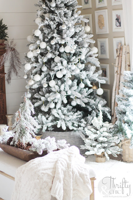 Christmas living room decor and decorating ideas. Christmas decor ideas for dough bowls. Farmhouse Christmas decor. Flocked Christmas trees. Shiplap wall and Christmas. Antique styled wood mantel. Wood mantel Christmas decor.