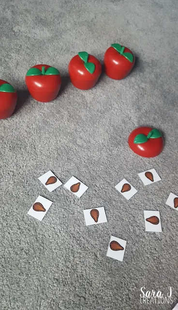 A cute way to tie in Ten Apples Up on Top with some gross motor and balance practice for toddlers!  Balancing apples plus a free appleseed counting activity is perfect for young kids to try in the fall.