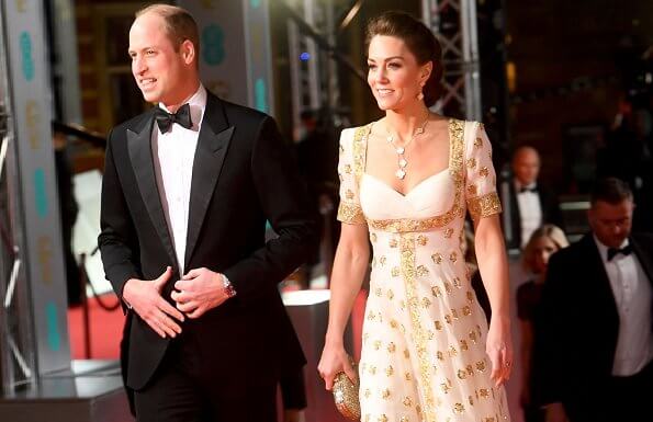 The Duchess wore a gown by Alexander McQueen. Jimmy Choo Romy gold pumps, She carries Anya Hindmarch gold glitter box clutch