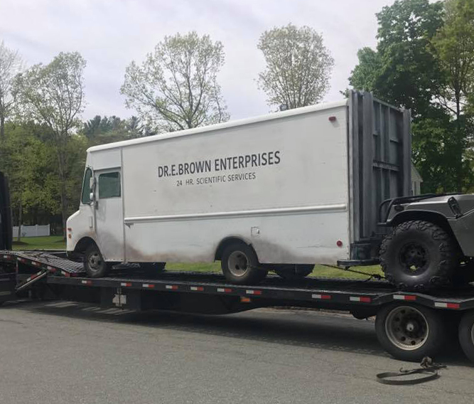 Just A Car Guy Doc Browns van.... and Delorean transporter. That's a