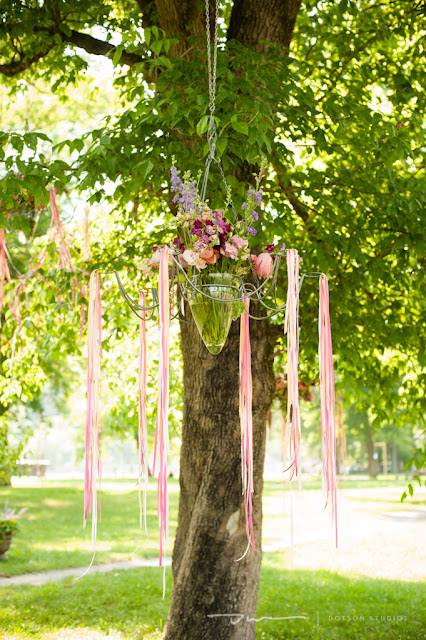 floral hanging in tree, floral with ribbons, outdoor floral arrangements, pink ribbons in trees, pink wedding design