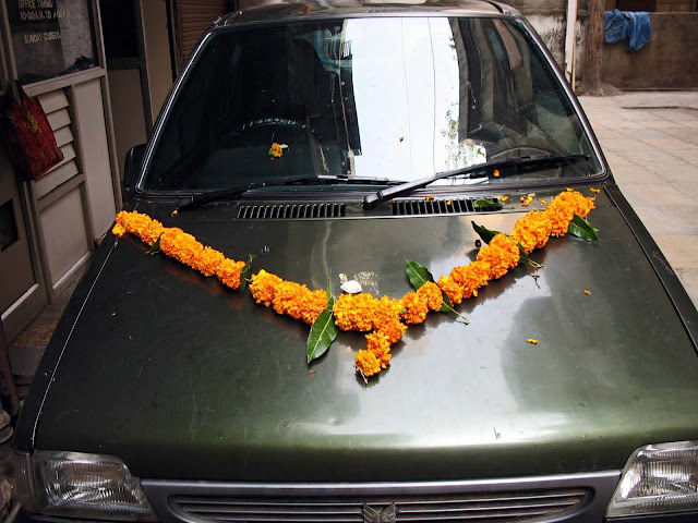 car decorated with marigold garland