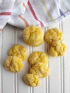 lemon gooey butter cookies on white background with striped towel