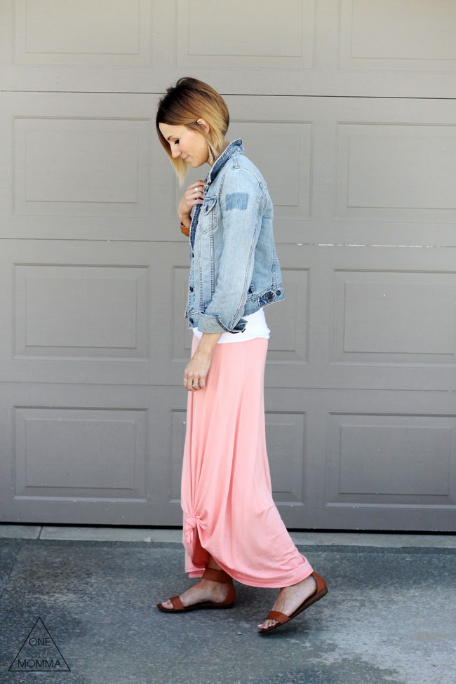 Denim jacket, white tee, and a  peach maxi skirt tied up in a knot.