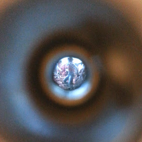 Tiny miniature cowboy figure, seen through a peep hole.