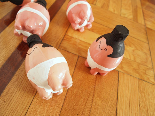 sumo wrestler bowling pins knocked over