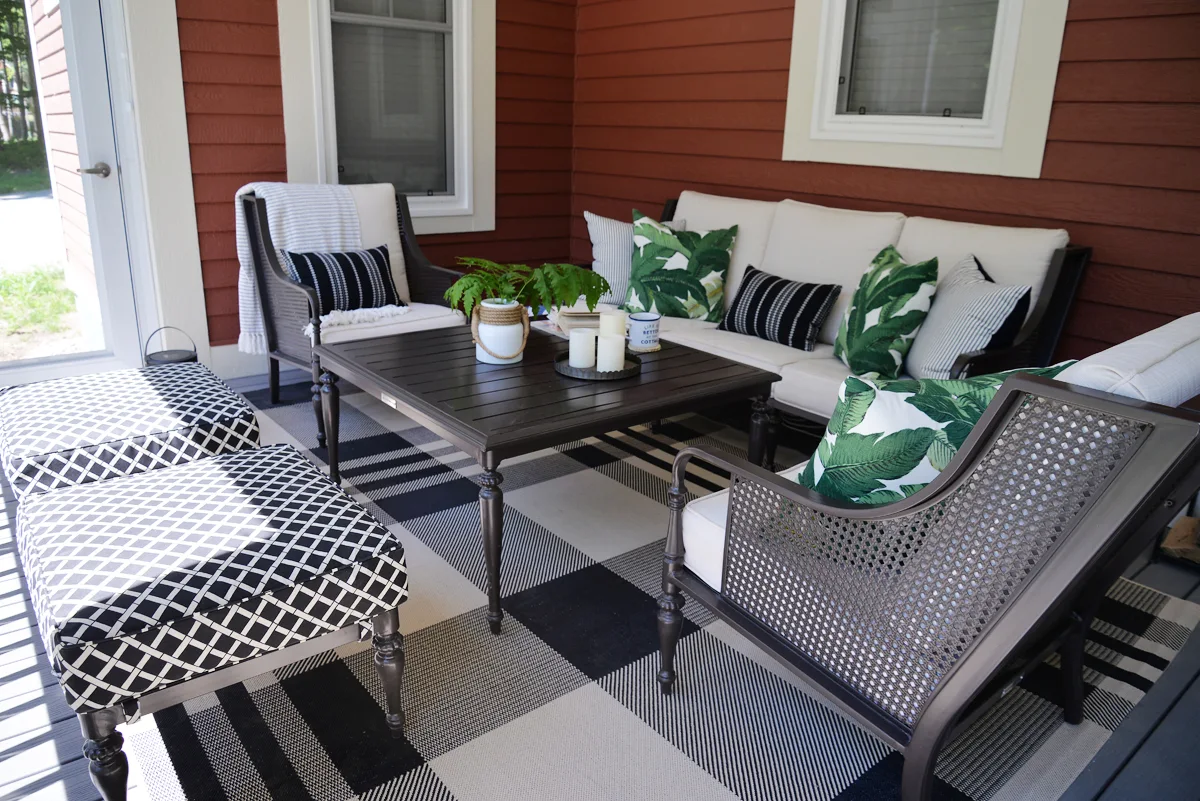 RamblingRenovators.ca | porch decor | outdoor caned wingback chair, plaid outdoor rug, palm leaves, cottage tropical decor