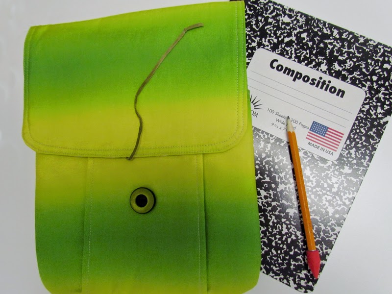 Idea Pouch holds composition notebook, pens, pencils, crayons