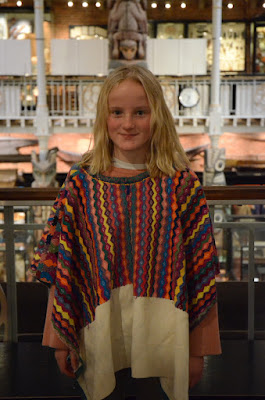 Girl wears a brightly coloured woven tunic