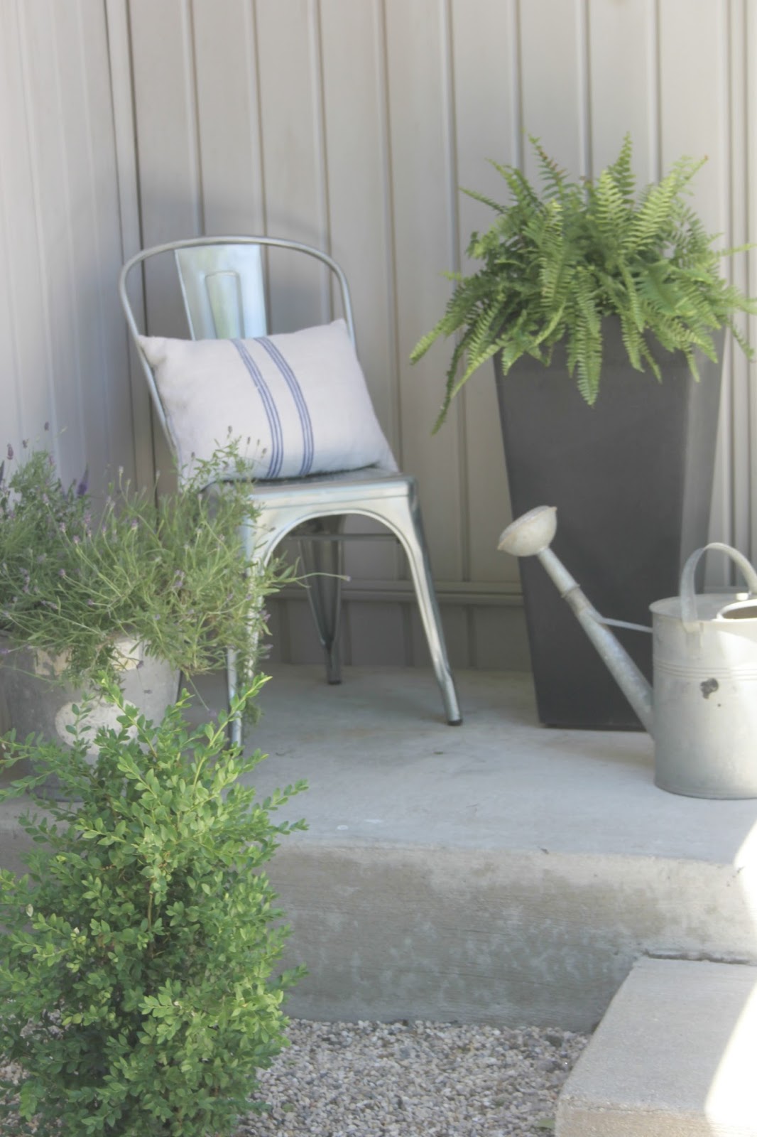 French farmhouse inspired porch. A mix of old and new, a relaxed approach to decor and shopping, and plenty of creativity yield a timeless look that isn't dependent on following trends or disposable decor. Come read more practical decor advice from Hello Lovely.