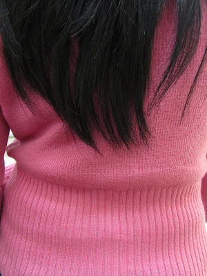 pink sweater and black hair