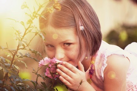 child sniffing a rose copyright 123rf photo