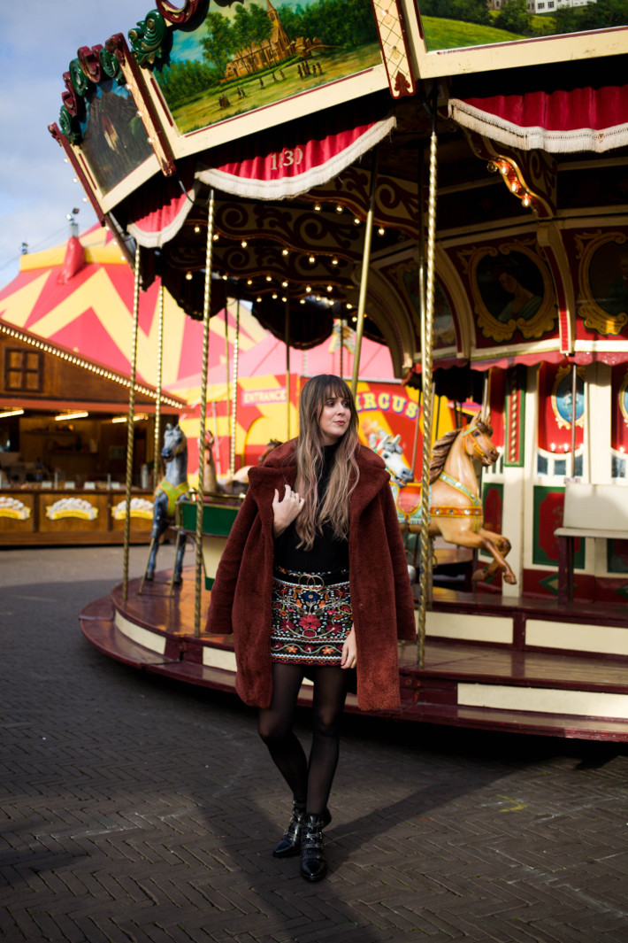 rust coloured teddy coat, embroidered skirt, buckle boots
