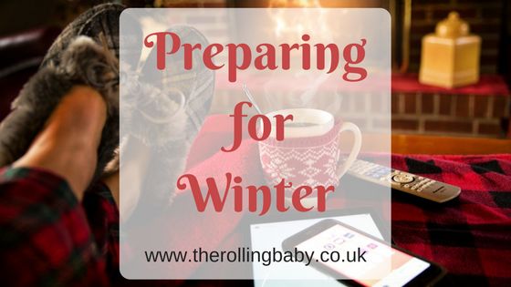 Preparing for Winter Person wearing slippers with their feet up in front of a fire. A mug, mobile phone and remote control sit beside them.