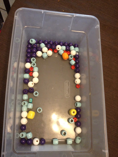box of colored wooden beads