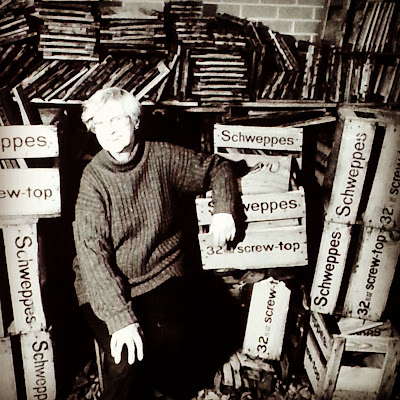 Assemblage artist Rosalie Gascoigne pictured in her studio surrounded by old Schweppes crates and pieces of (often stored in the crates). 