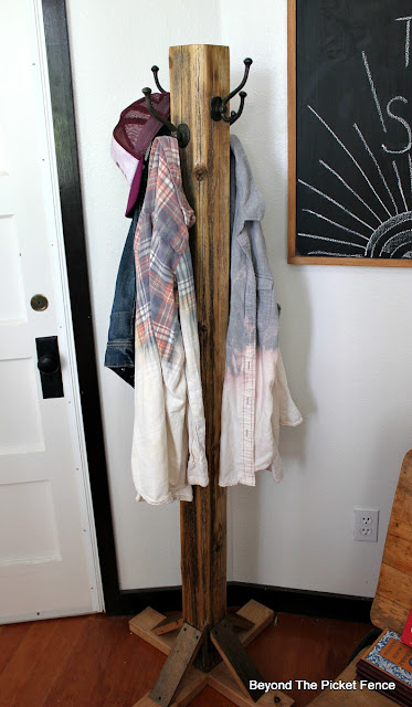 use a reclaimed wood fence post to make a coat tree