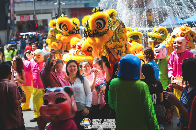 A happy family spotted taking photos with the lion dance outside Pavilion KL
