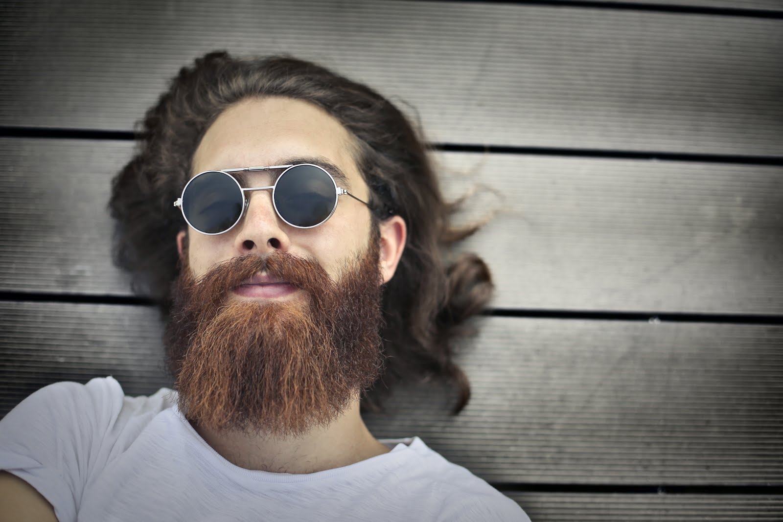 4 Tips for Better Beard Growth and Beard Maintenance Man with Beard and Glasses