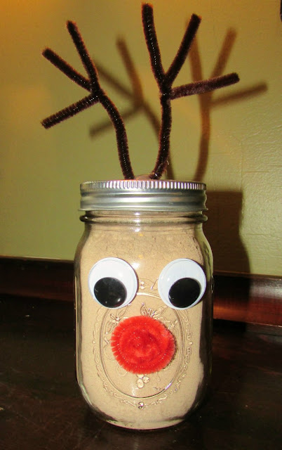 Hot chocolate mix is easy to make at home, just get out your food processor and a few simple ingredients. Then you can store it in a jar so you are ready when you need a hot delicious chocolaty drink! glass jar decorated like Rudolph the red nosed reindeer and filled with hot cocoa mix