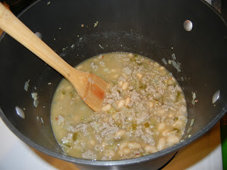 onion, peppers, and ground turkey browned in a pot with beans and stock 