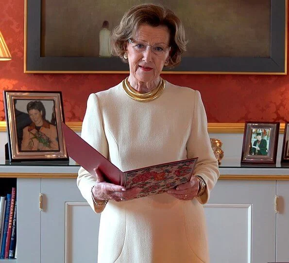 On the occasion of the International Nurses Day 2020, Queen Sonja' gold necklace by Dior. Valentino white dress
