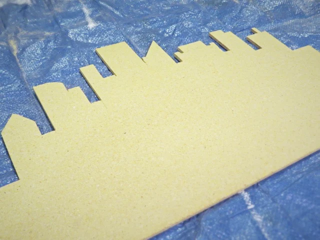 finished cut out of city scape splash blocker in wood panel