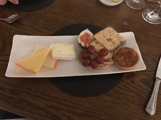 cheese and crackers on plate with figs 